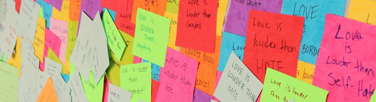 Collage of love is louder than colorful post its